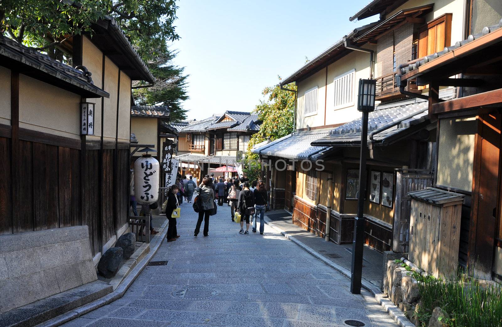 KYOTO, JAPAN - OCT 21 2012: Tourists walk on a street by siraanamwong