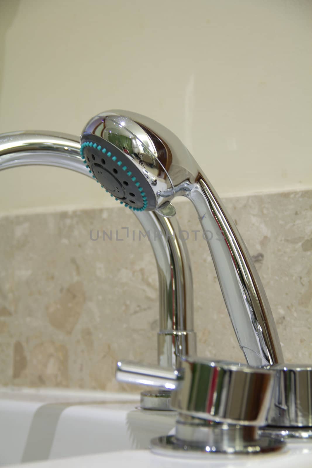 Silver chrome bathroom tap faucets running water in a sink