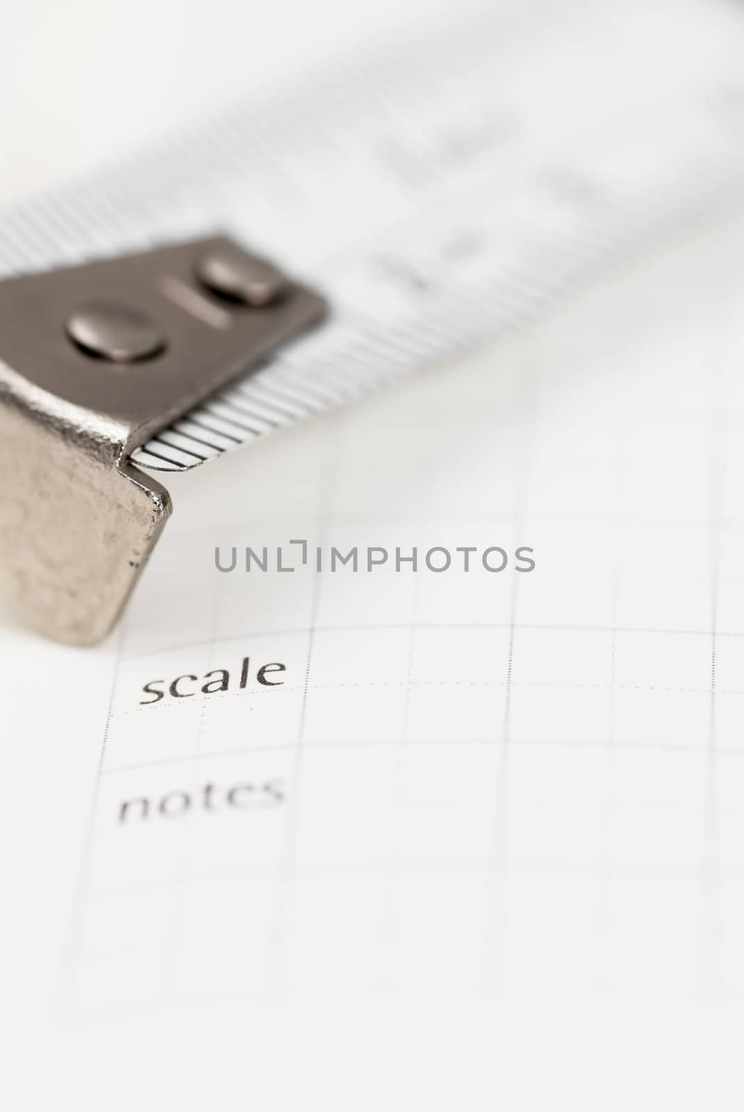 White tape measure on graph paper.