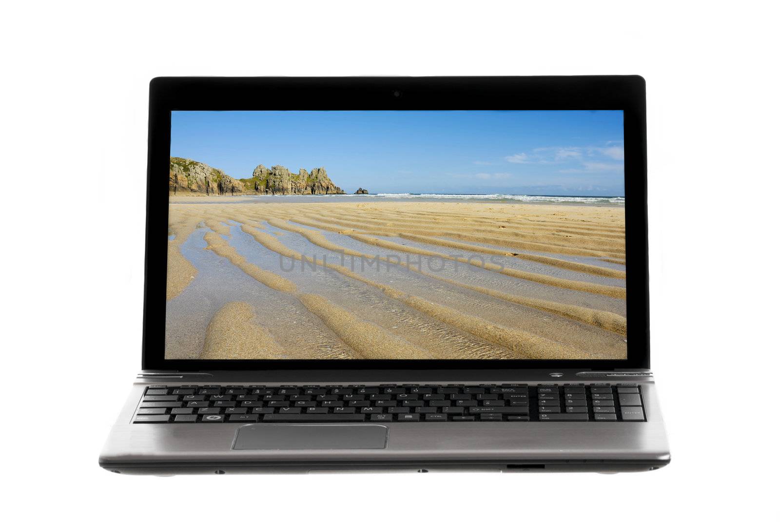 Laptop on white background showing landscape image on screen.