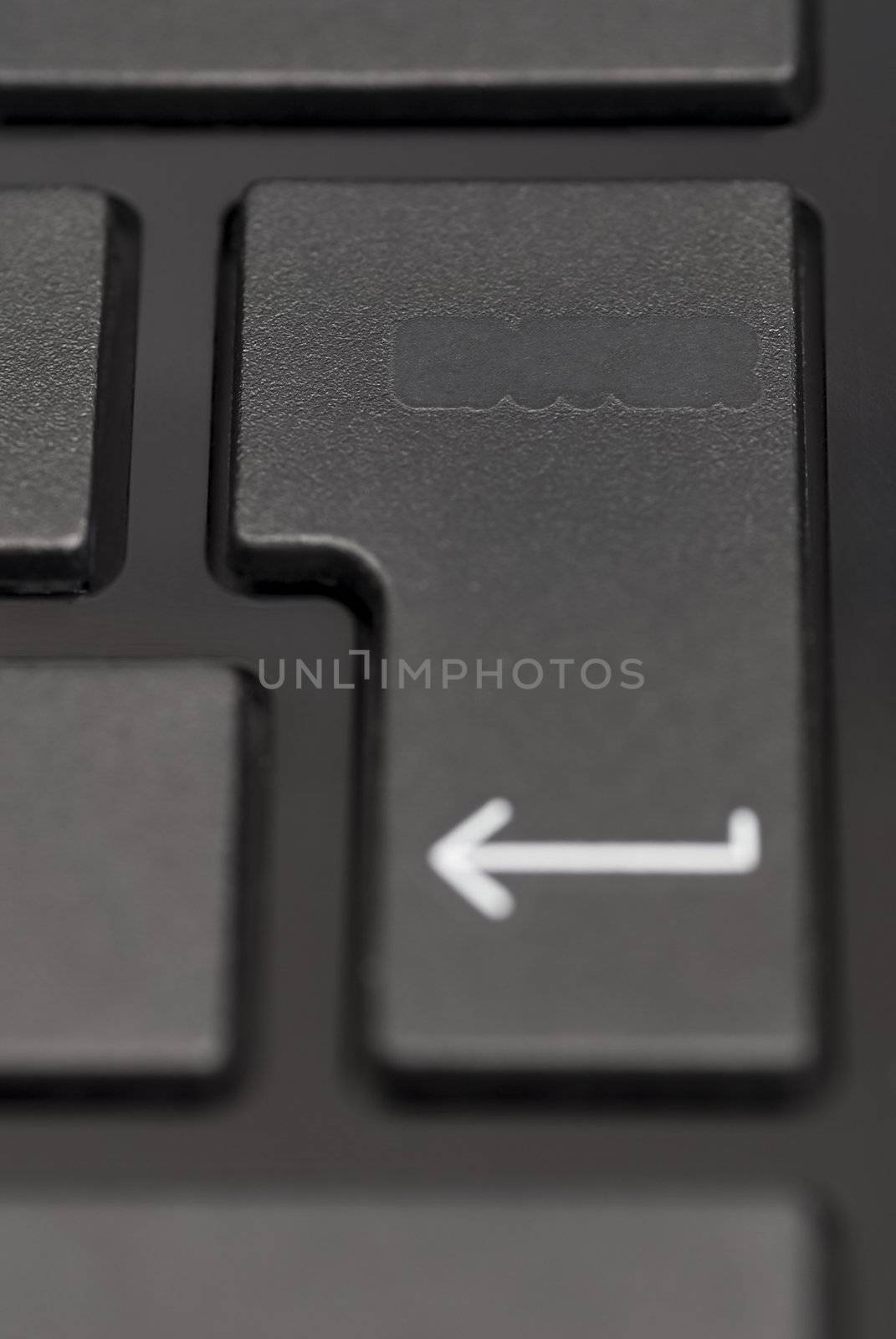 Detail of blank enter key on black laptop.