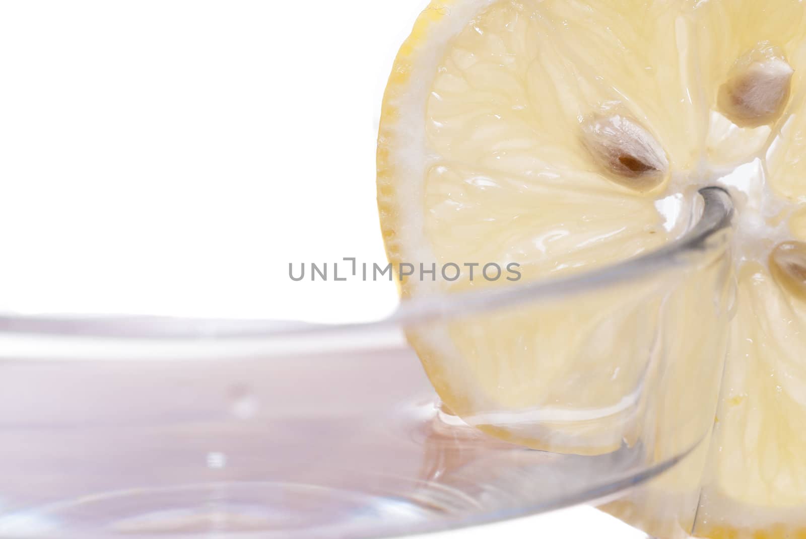 Cross section of sliced lemon in a glass.