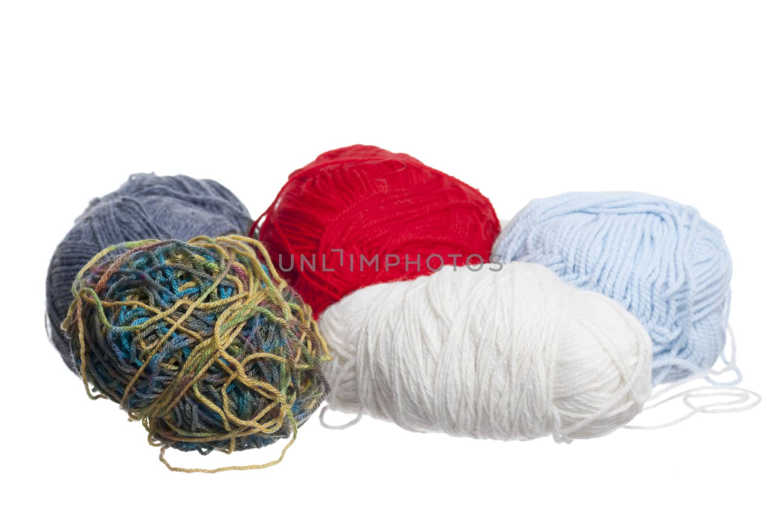 Multi-Coloured knitting wool, white background.