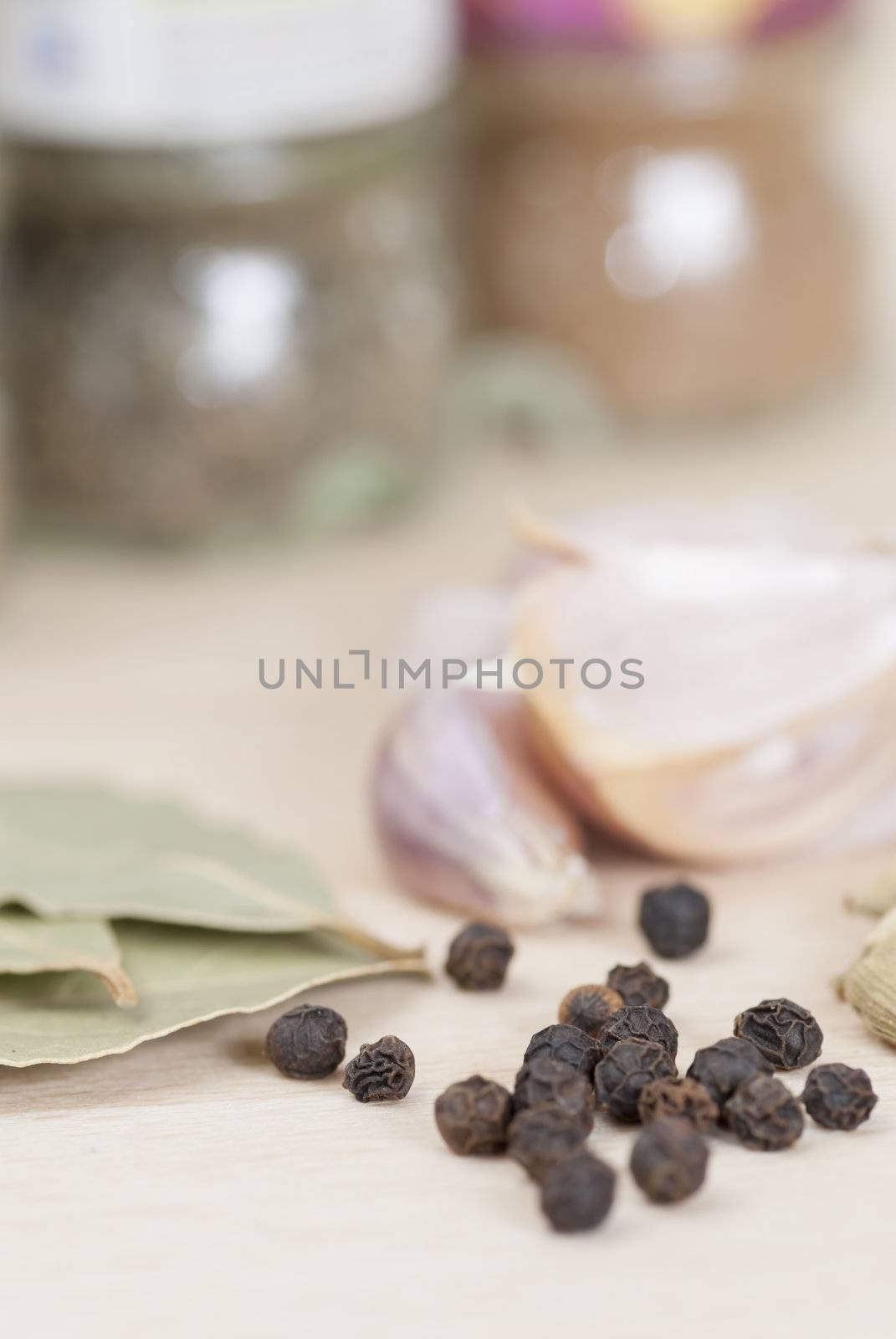 Garlic, Peppercorns, Bay Leaves on wooden kitchen surface