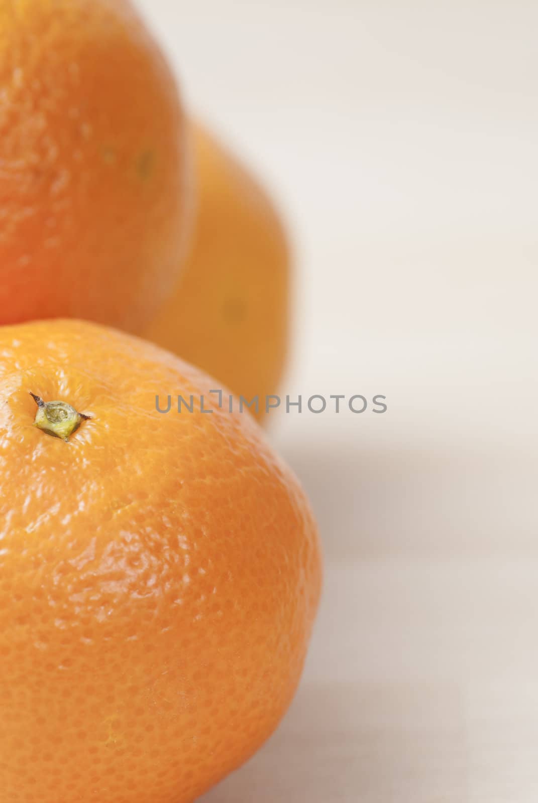 Group of Tangerines on wooden work surface.