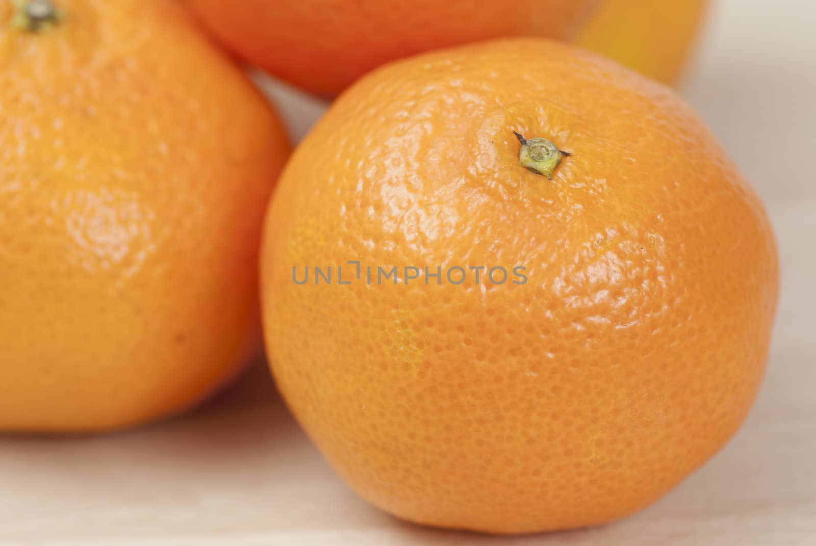 Group of Tangerines on wooden work surface.