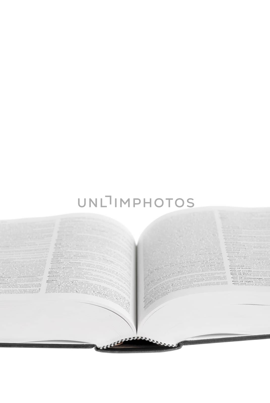 Large book open against white background.