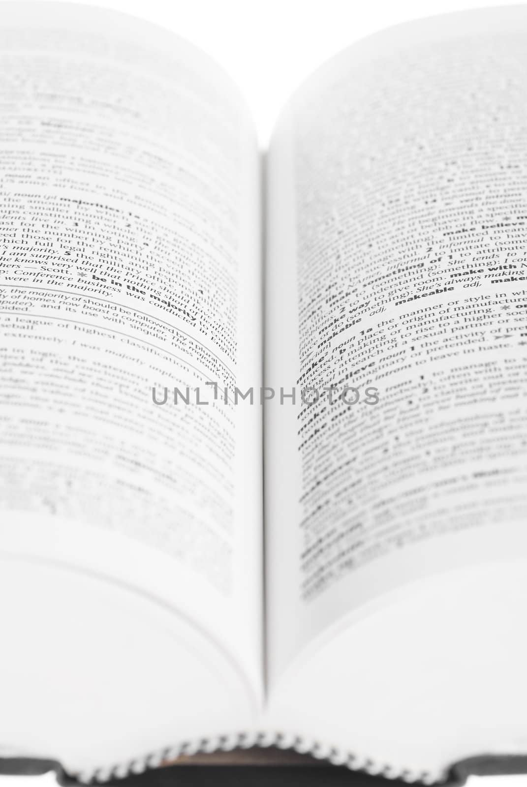 Large book open against white background.