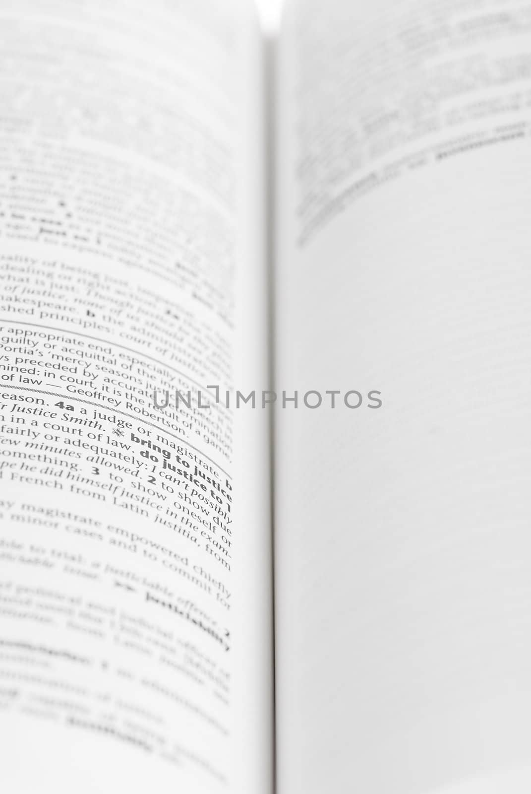 Large book open against white background.