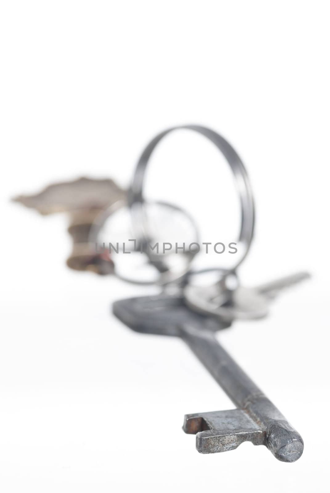 Set of keys on keyring. White background.