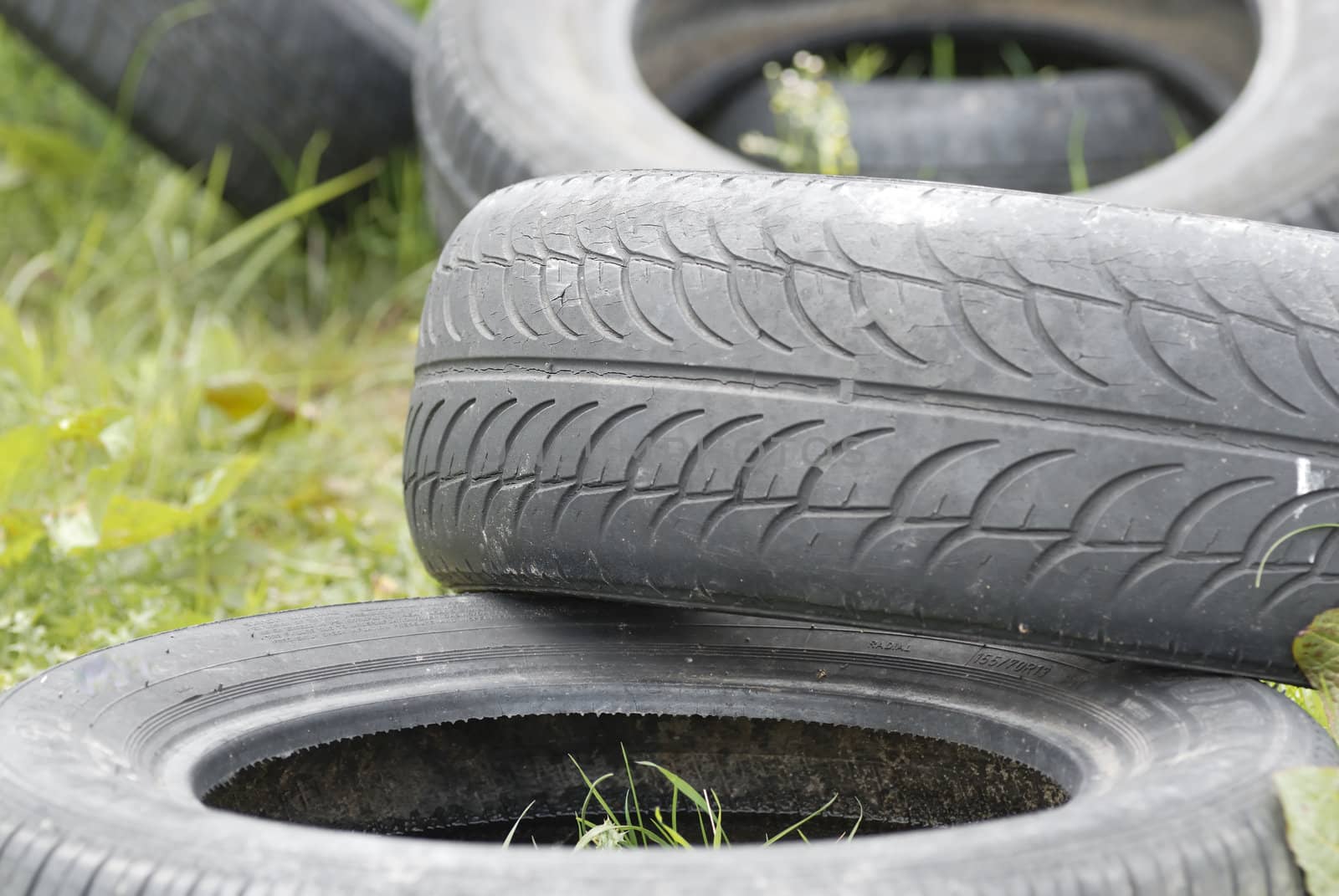 Used, dumped car tyres. Copy space.