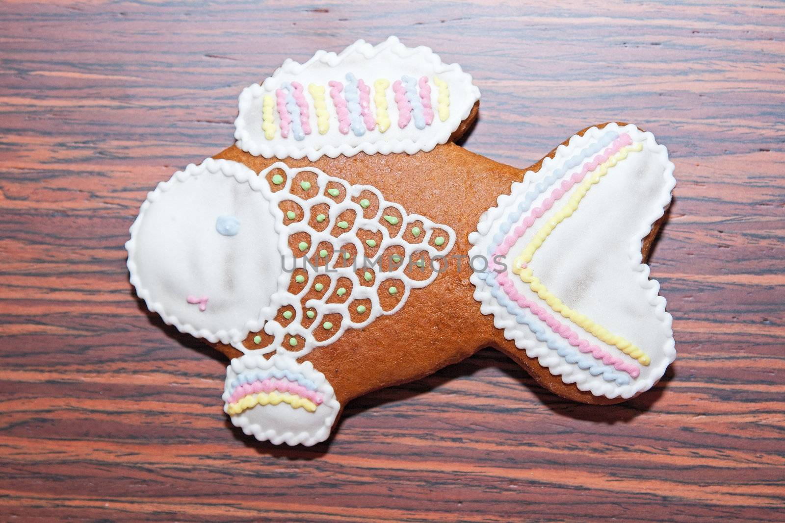 Gingerbread in the form of a fish on a wooden background