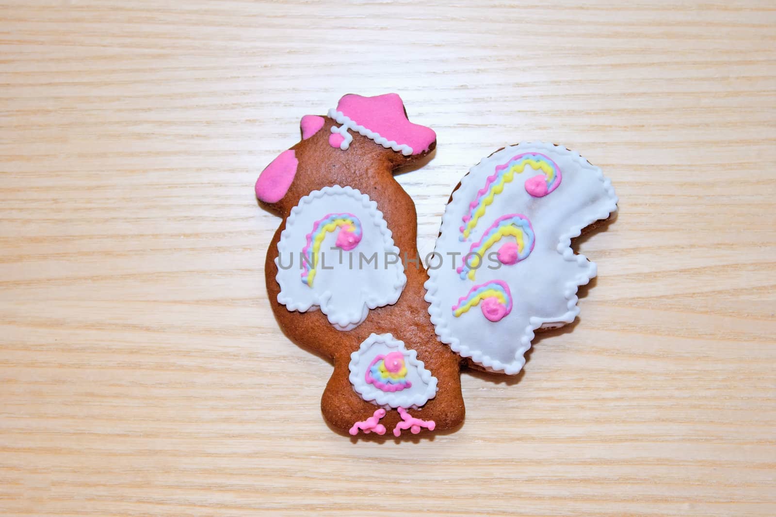 Gingerbread in the form of a bird on a wooden background