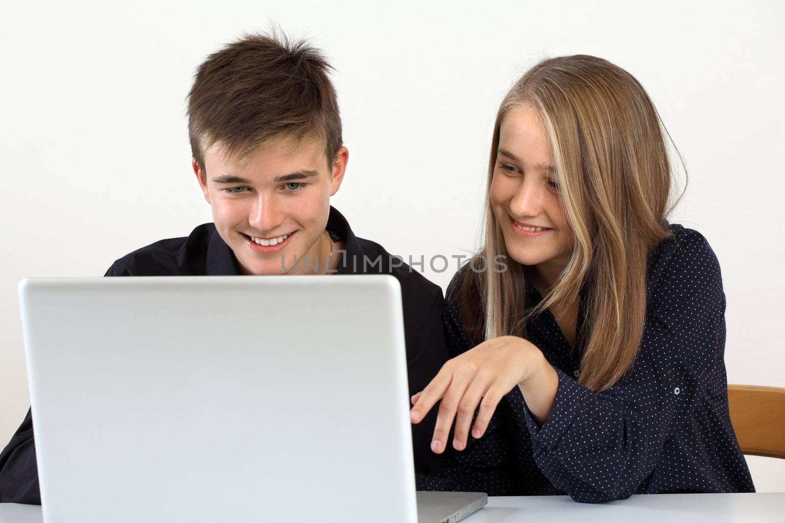 Young students working on a laptop by sumners