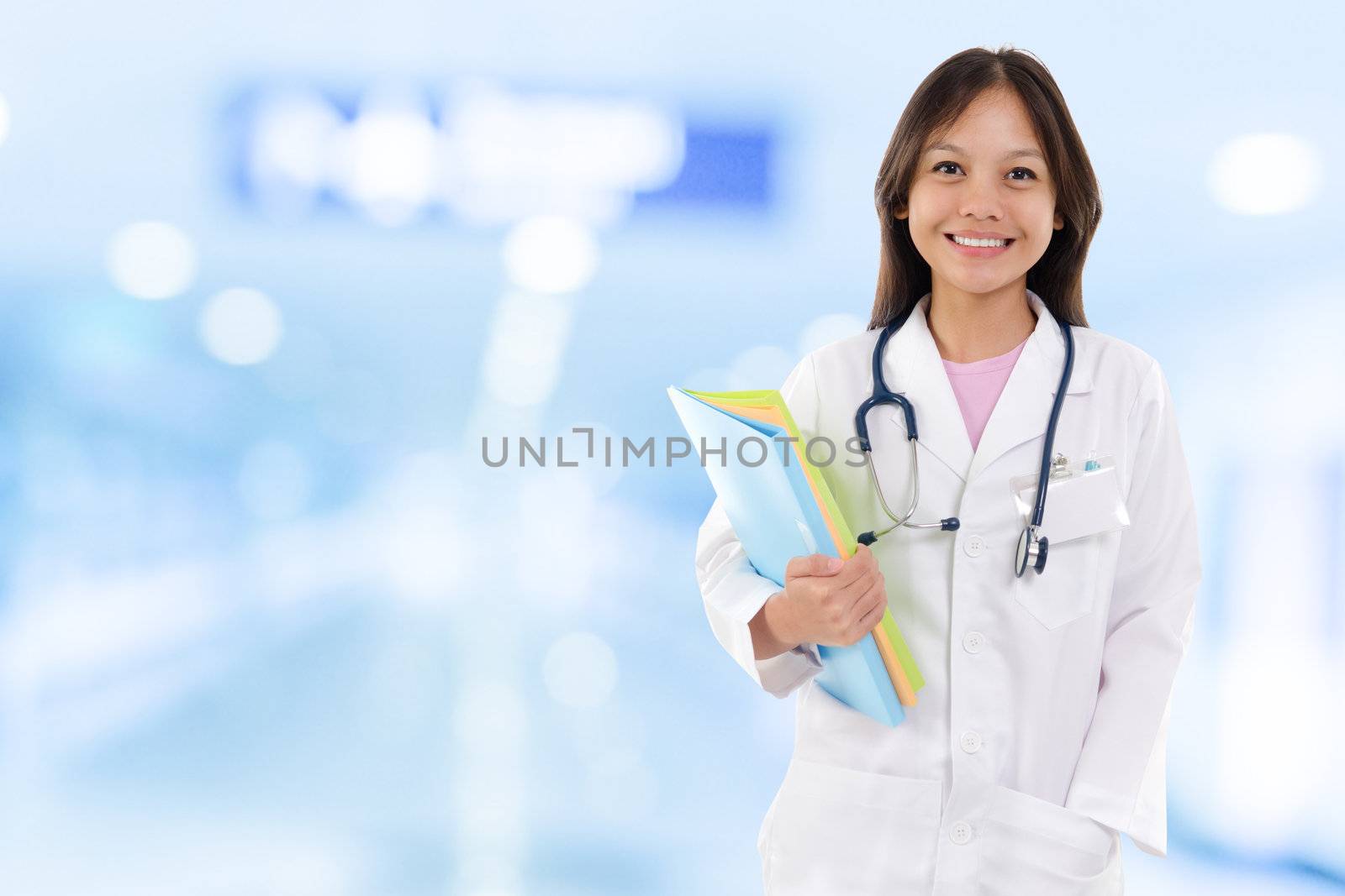 Young medical doctor woman. Southeast Asian medical student standing on hospital background.
