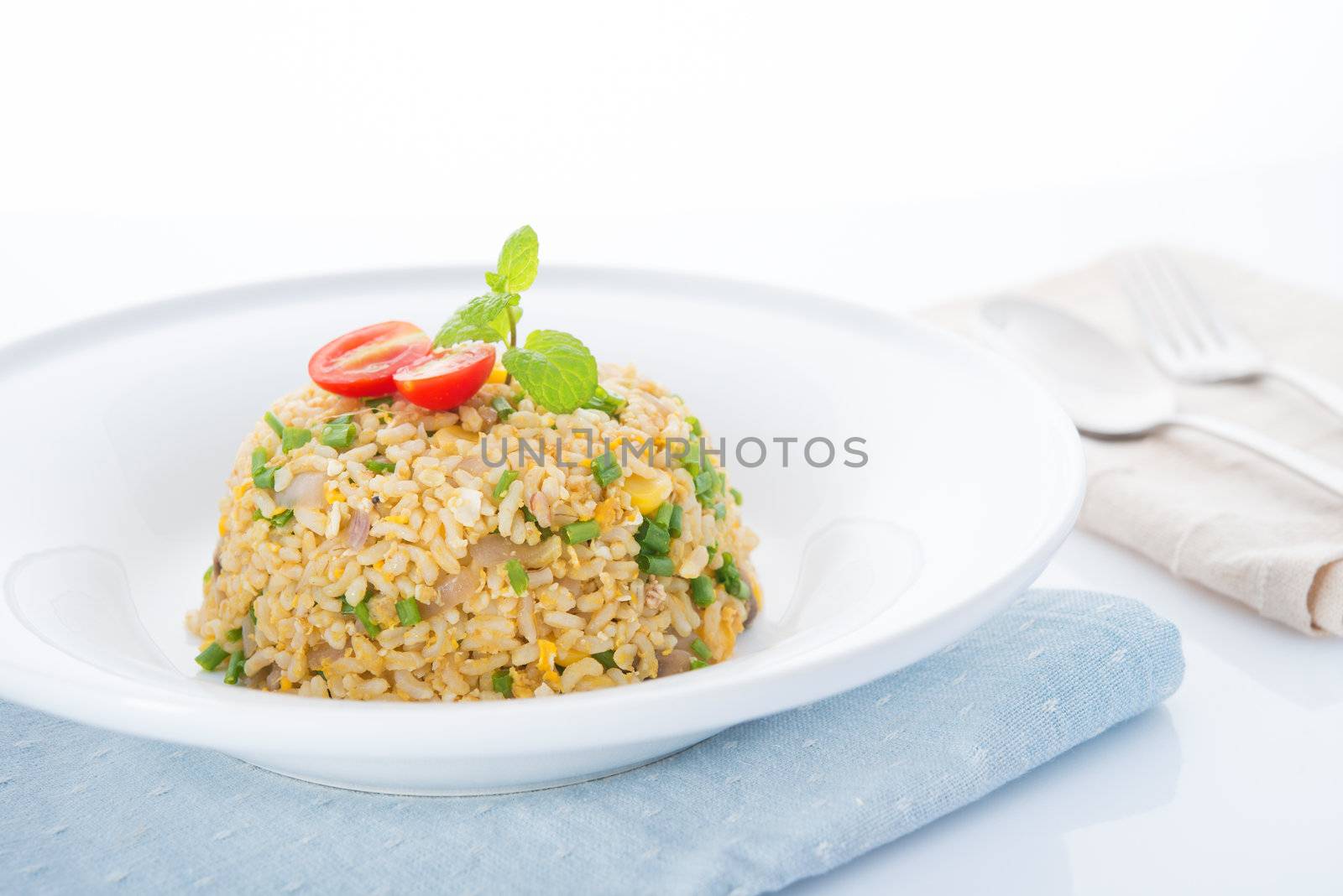 Chinese egg fried rice with spoon and fork on dining table