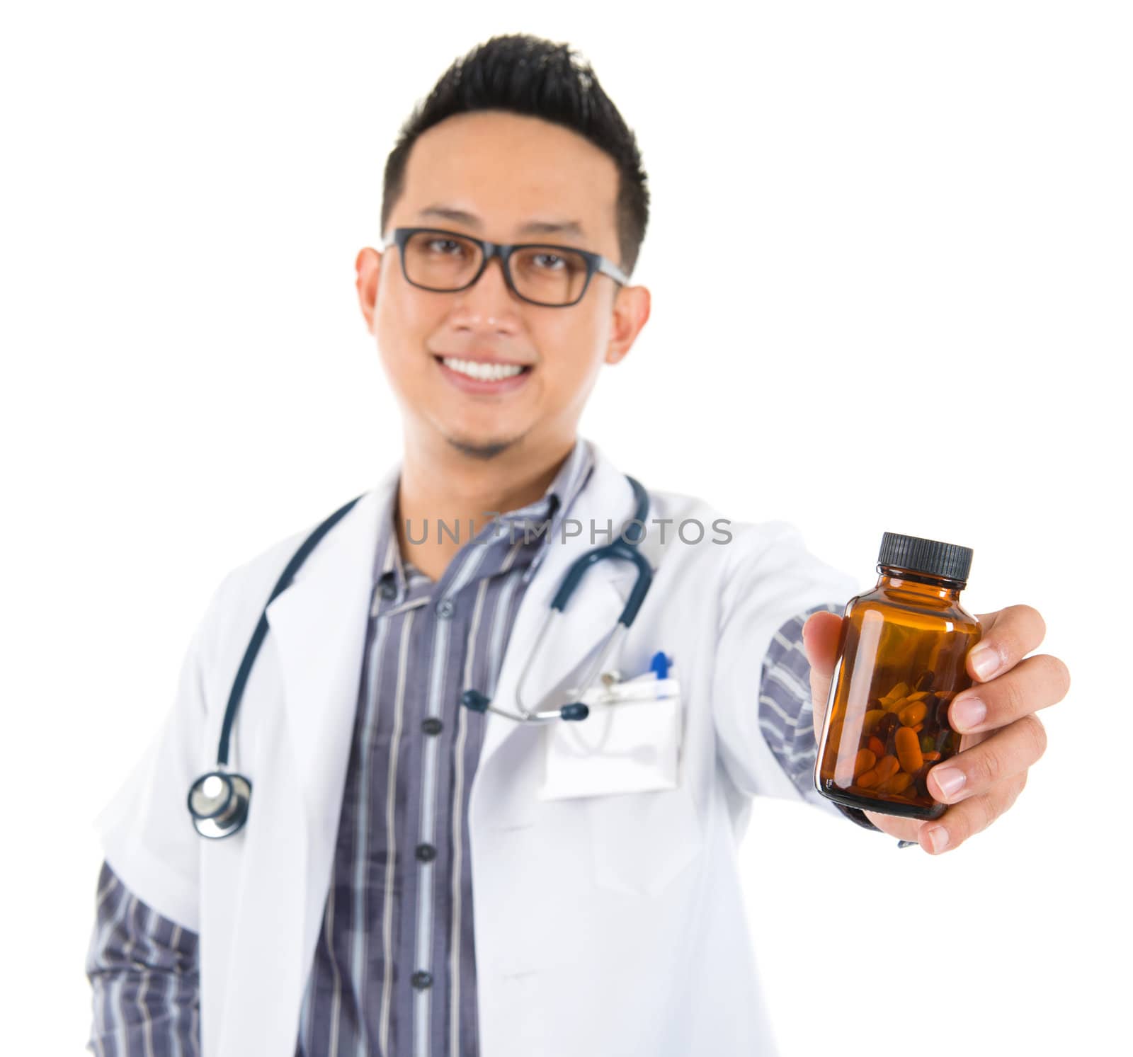 Southeast Asian medical doctor holding a bottle of pills, smiling isolated white background