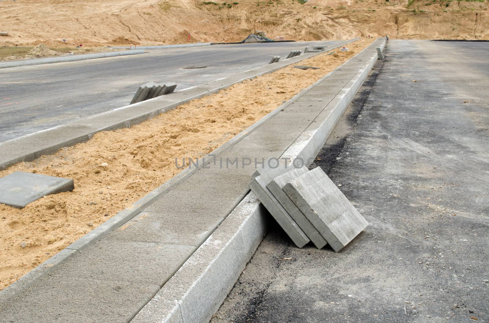 pavement tiles on new sidewalk. new highway asphalt road construction works.