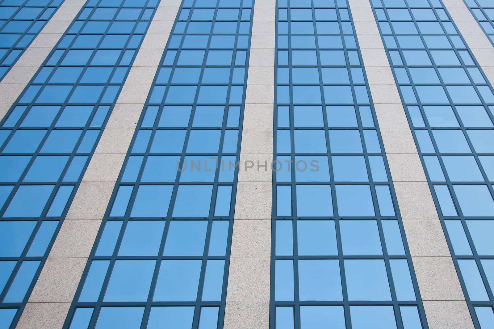 blue sky reflected in grid of windows by ahavelaar
