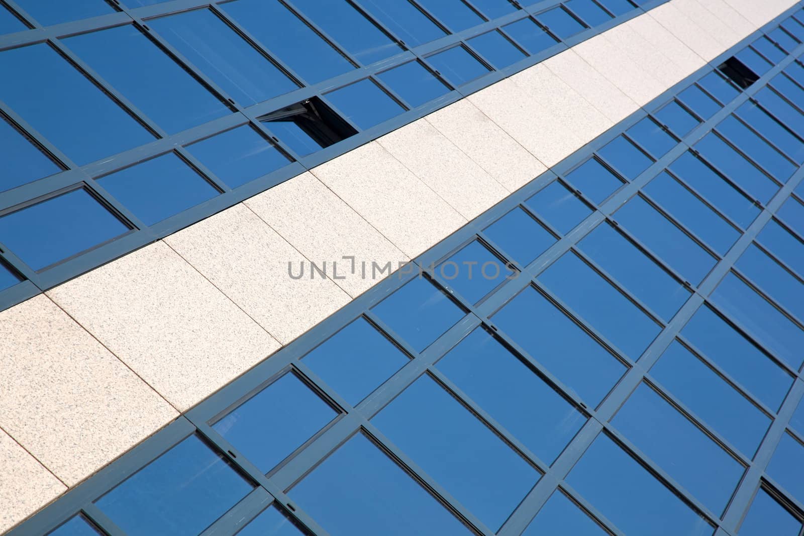 facade of office building with blue reflected by ahavelaar