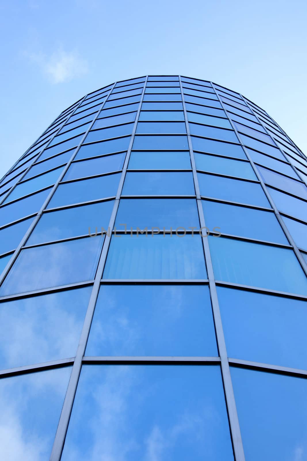 round facade of office building with blue reflected by ahavelaar