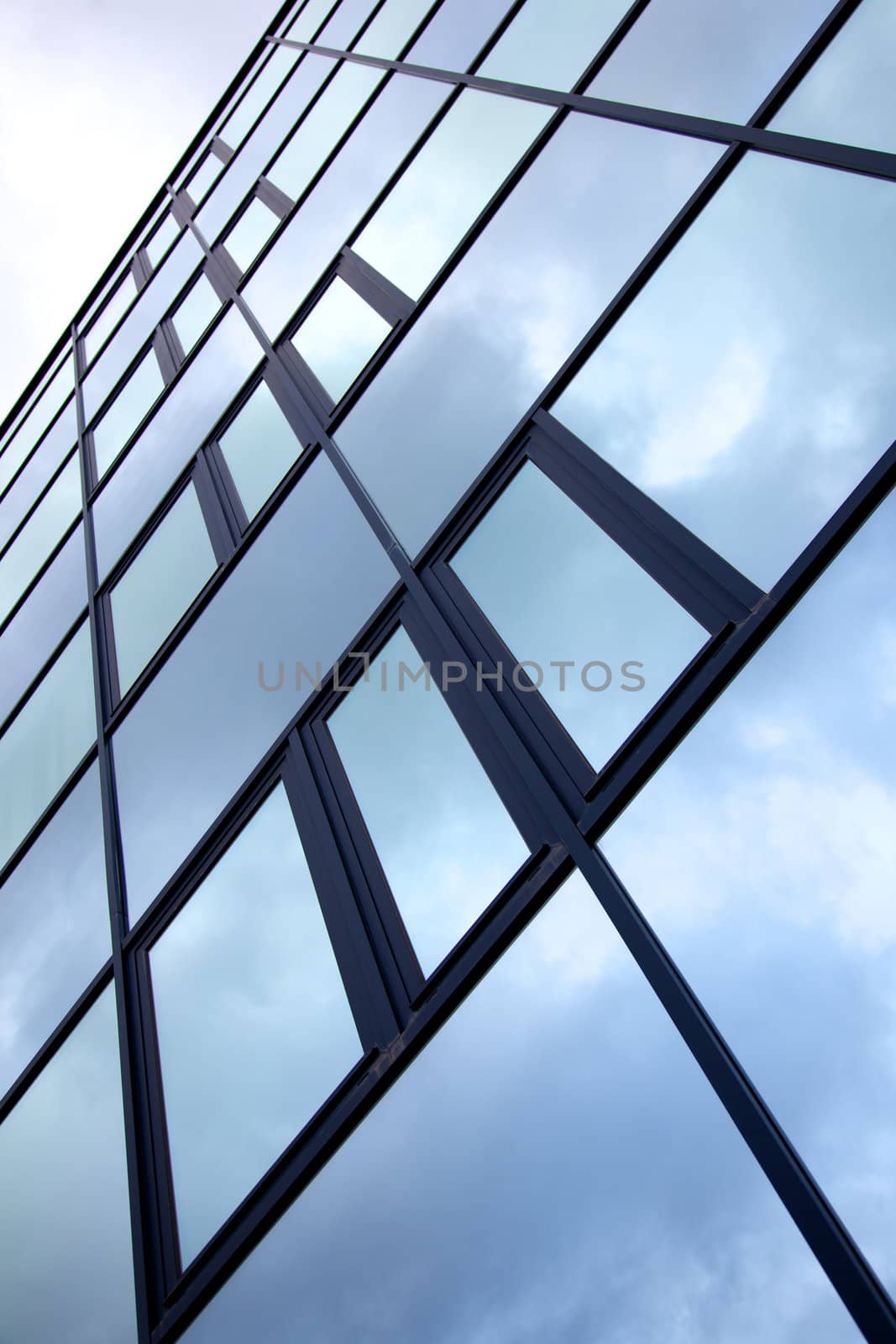 facade of office building with overcast sky reflected