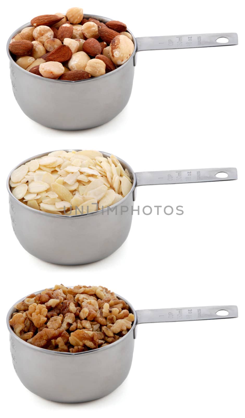 Whole nuts, flaked almonds and chopped walnuts in cup measures, isolated on a white background