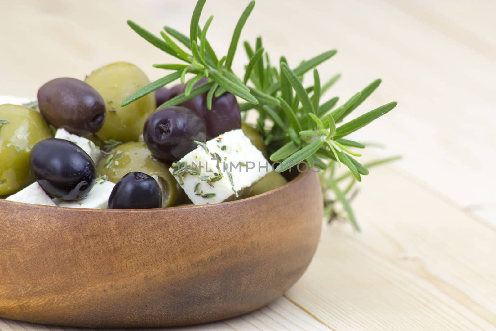 feta cheese and olives with herbs in olive oil