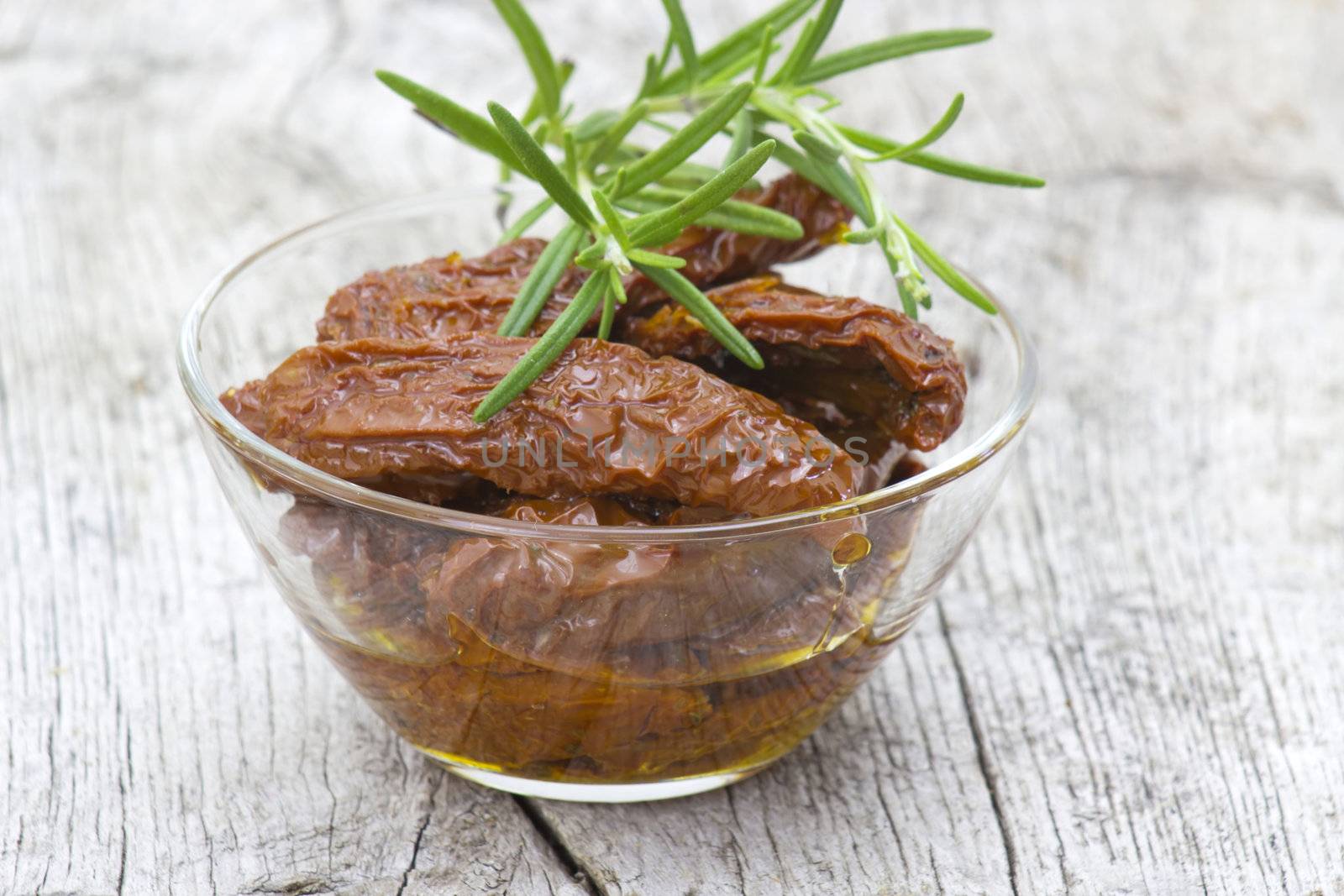 dried tomatoes with olive oil in a bowl 