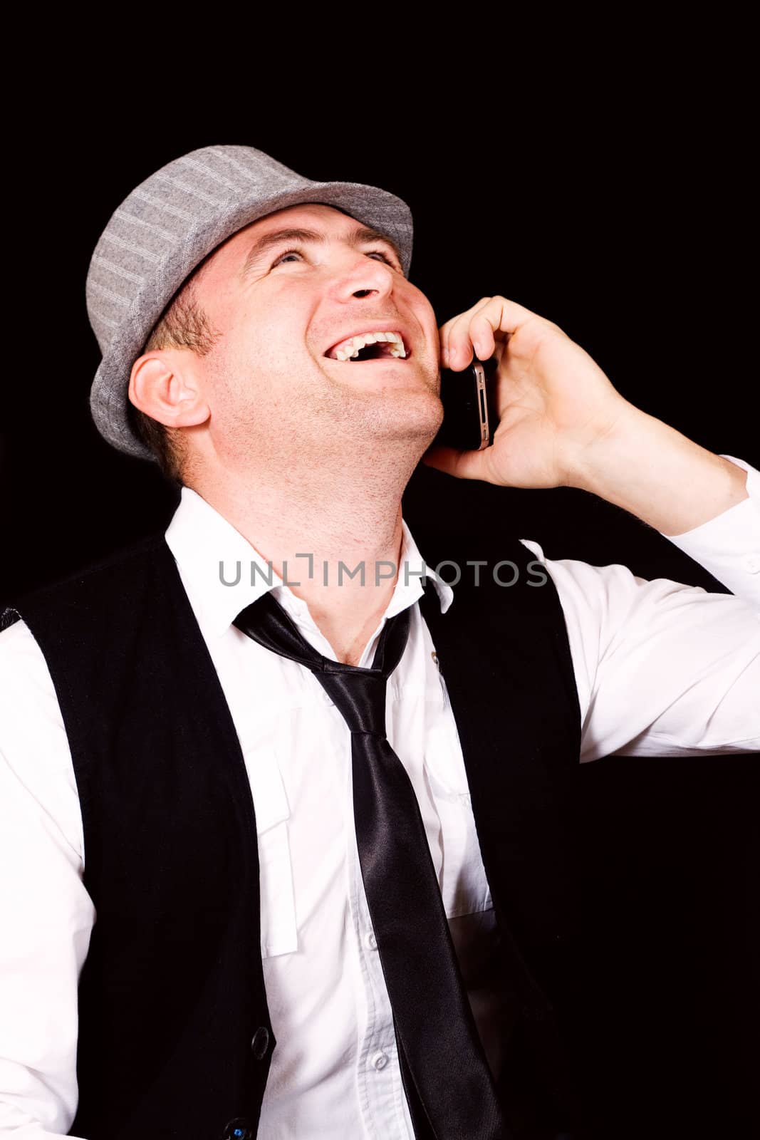 Close up of a young modern business man, busy talking on his mobile phone, big smile on his face. 