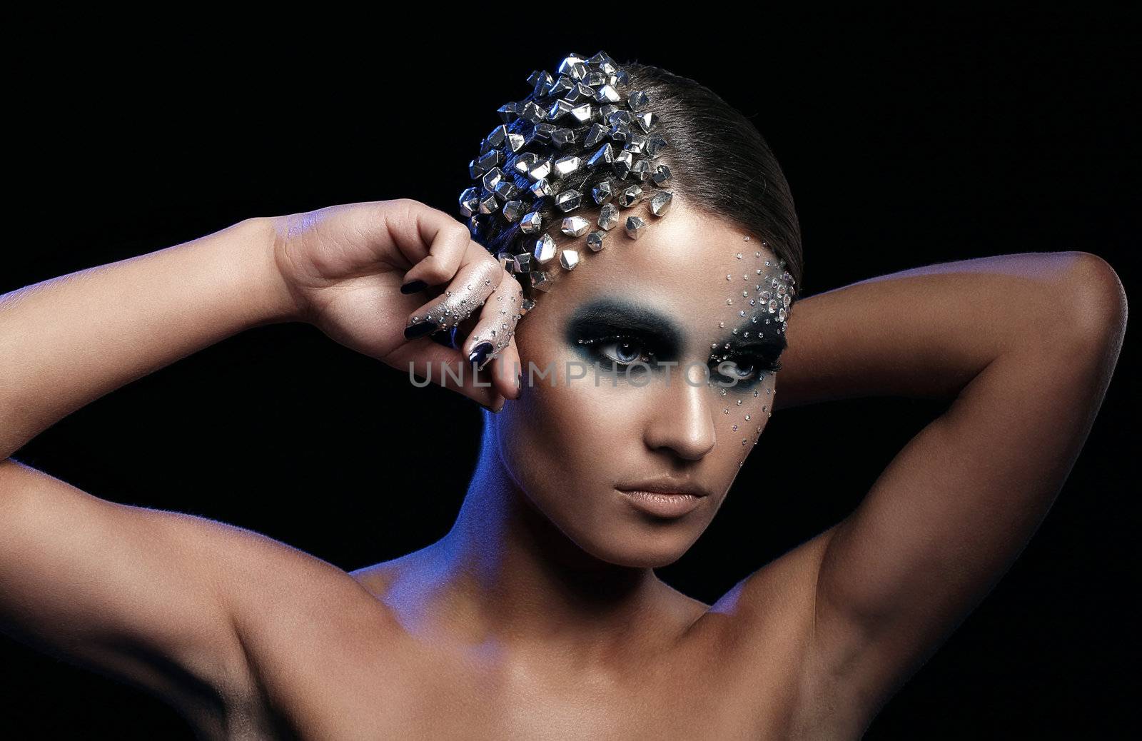 Portrait of woman with artistic make-up isolated over black background