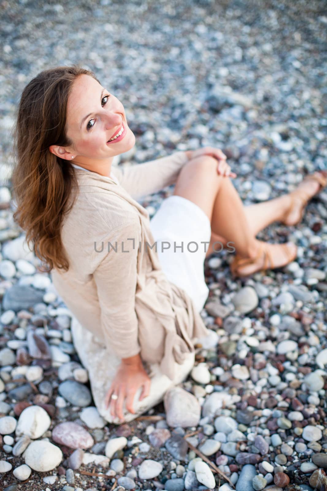 Young woman on the beach enjoying a warm summer evening