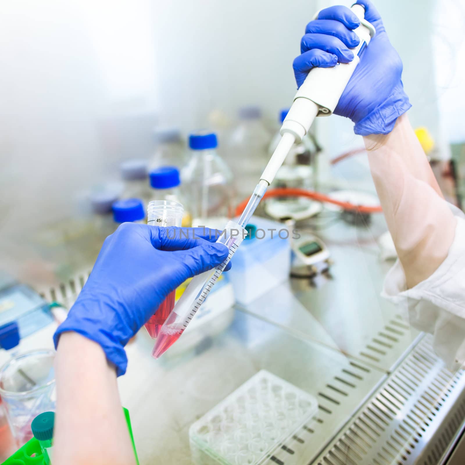 Portrait of a female researcher doing research in a lab (shallow DOF; color toned image)