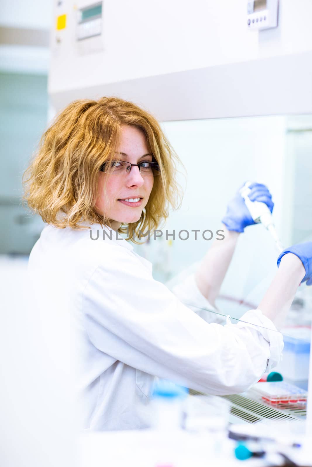 Portrait of a female researcher doing research in a lab (shallow DOF; color toned image)
