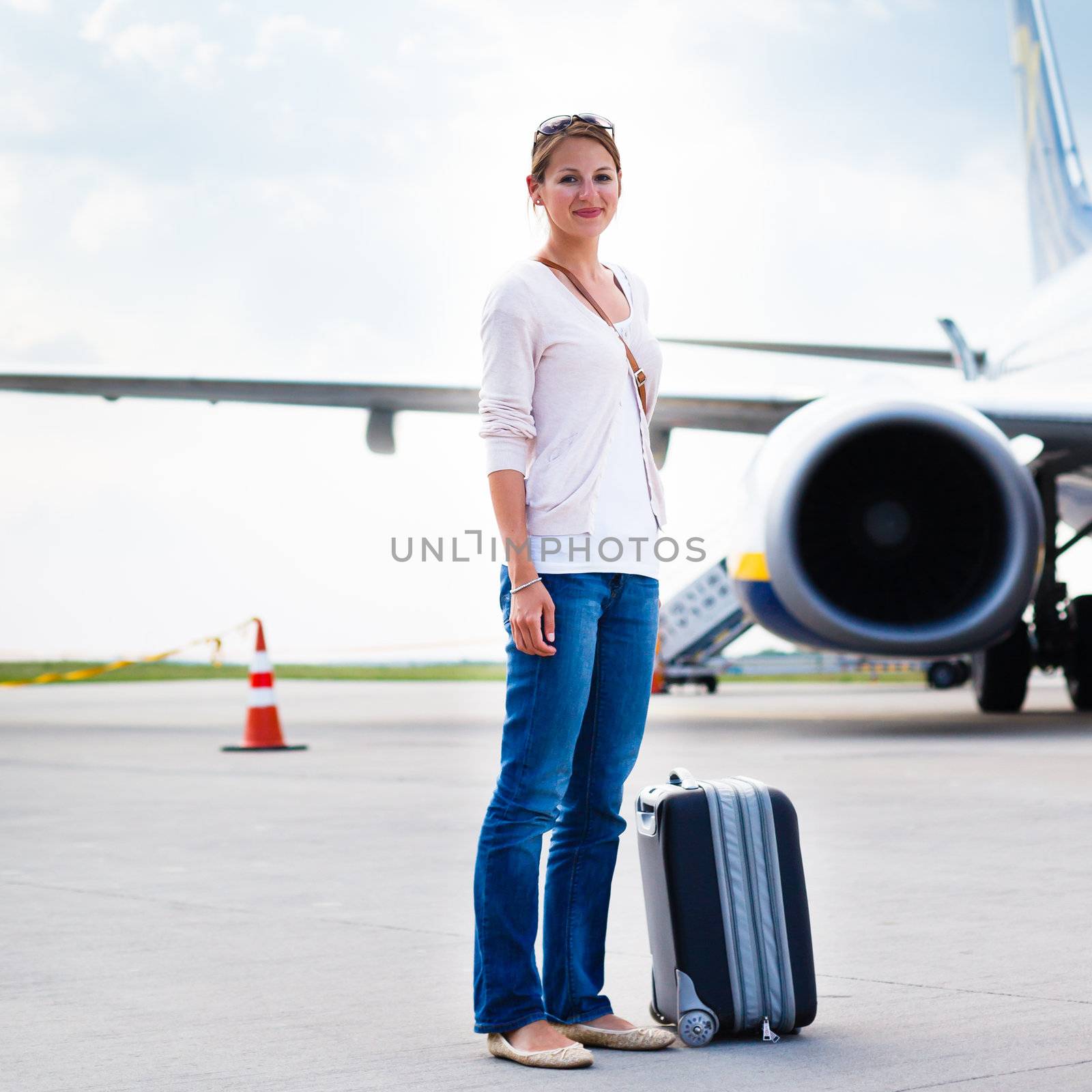 Young woman at an airport having just left the aircraft by viktor_cap