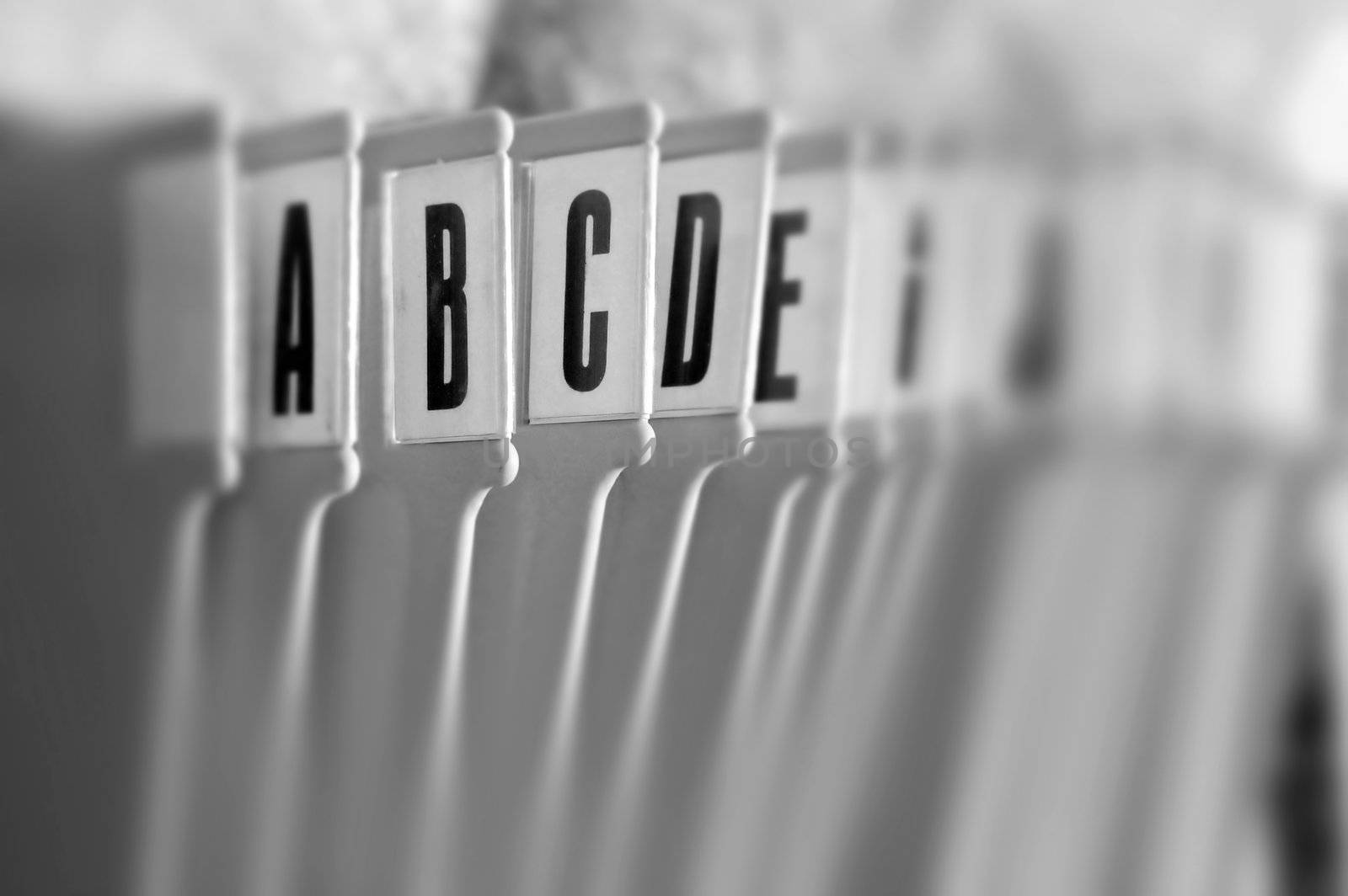 Alphabetical filing tray office index organizer. Selective focus black and white.