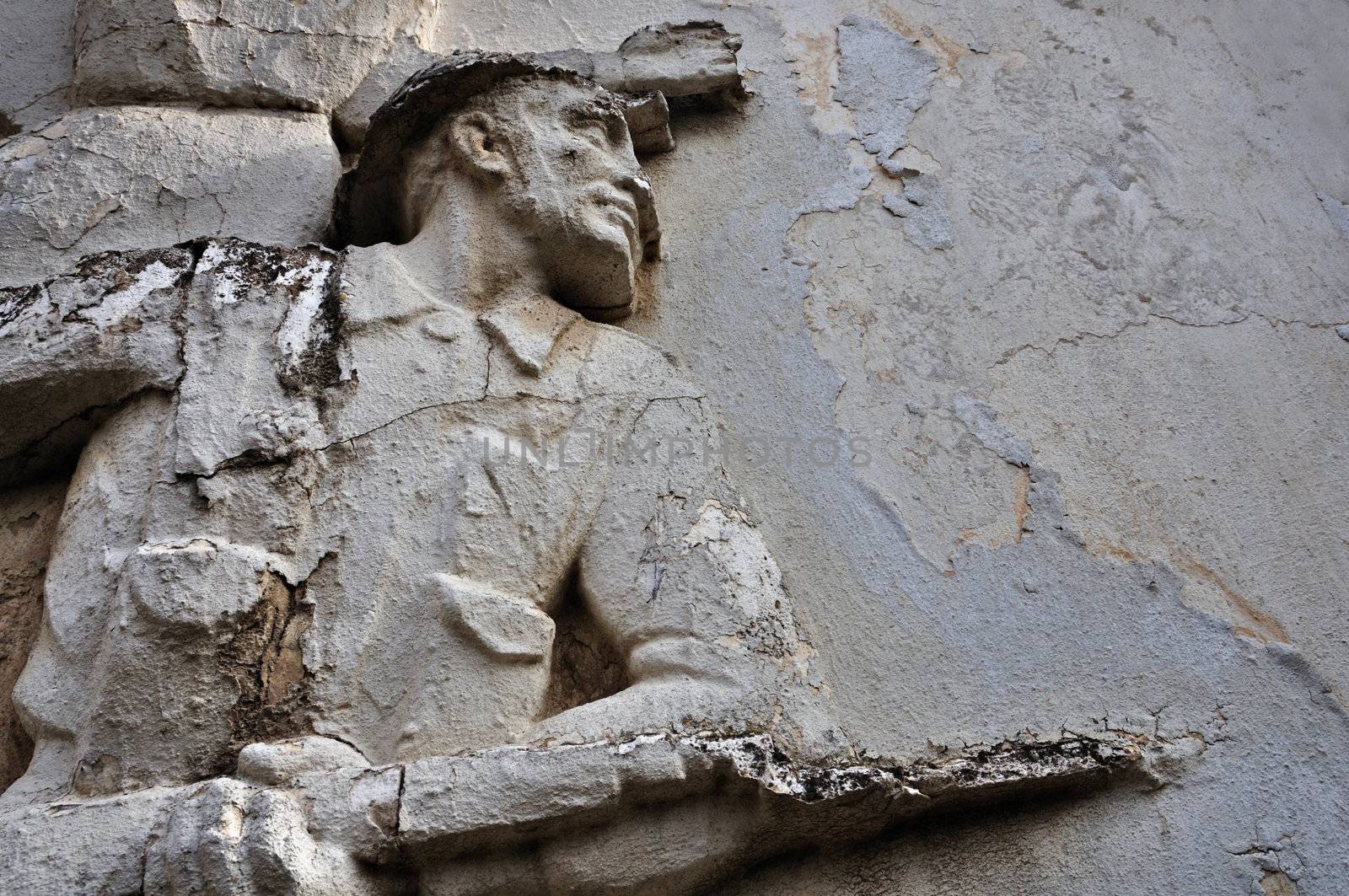 ATHENS - FEBRUARY 3: Entablature of soldier with broken bayonet on weathered wall exterior at the abandoned house of sculptor Nikolaos Pavlopoulos in Athens Greece, February 3, 2012.