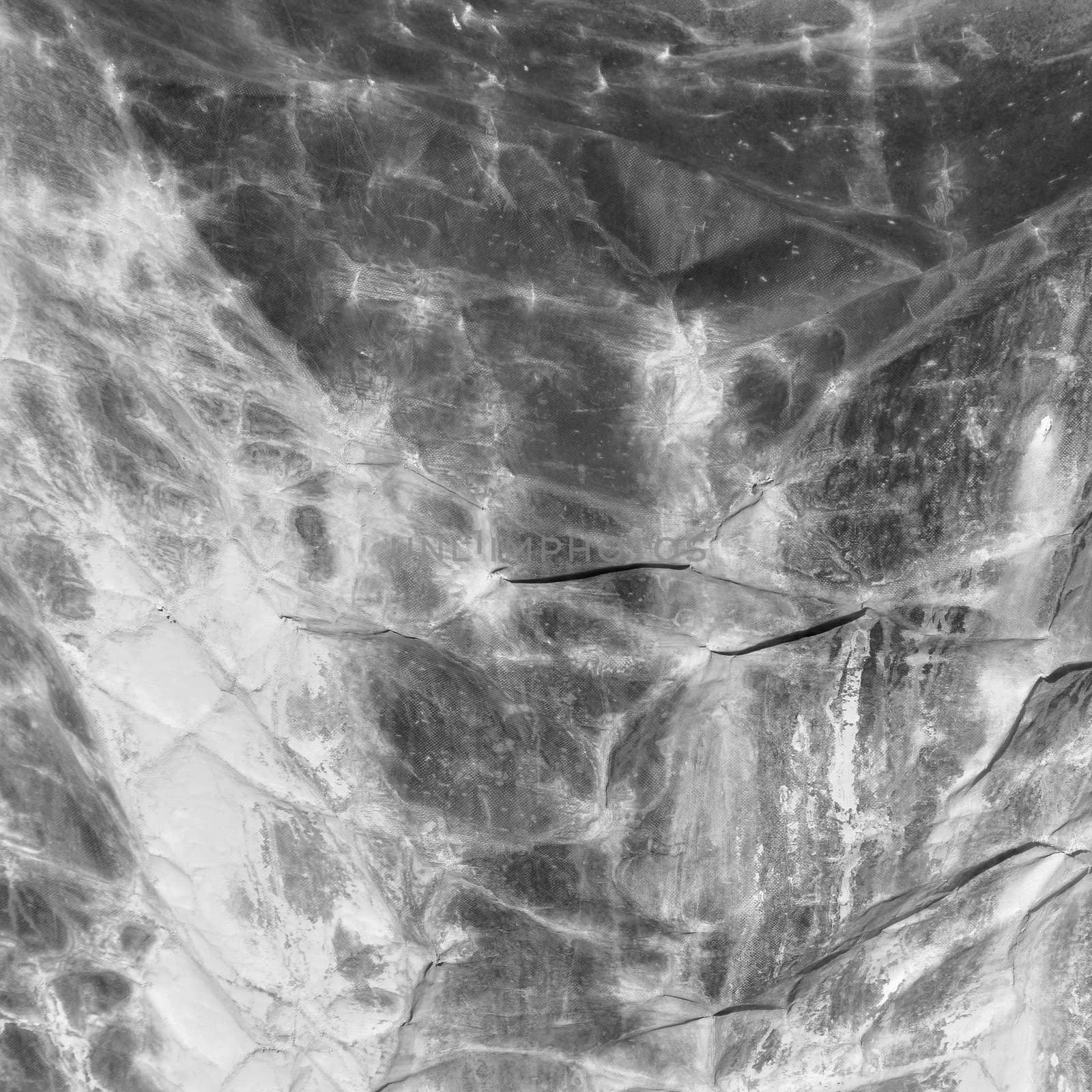 Marble dust stained creased canvas abstract background texture. Black and white.