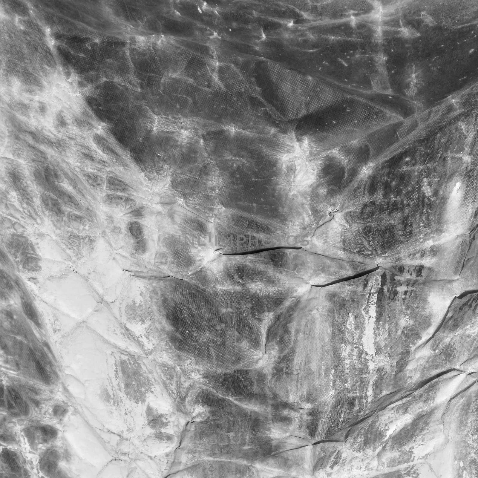 Marble dust stained creased canvas abstract background texture. Black and white.