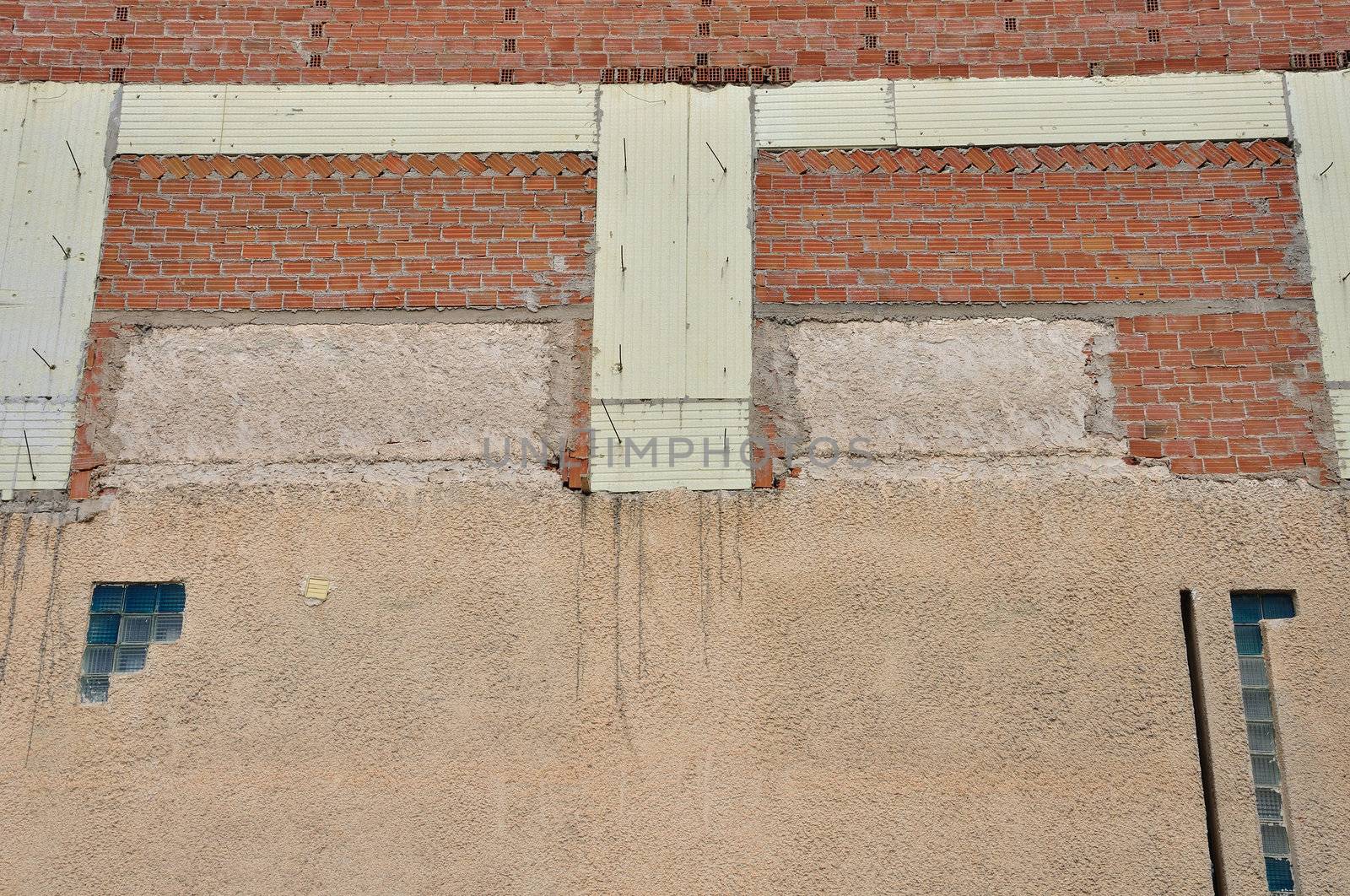 Brick wall and insulation material background. Building under construction.