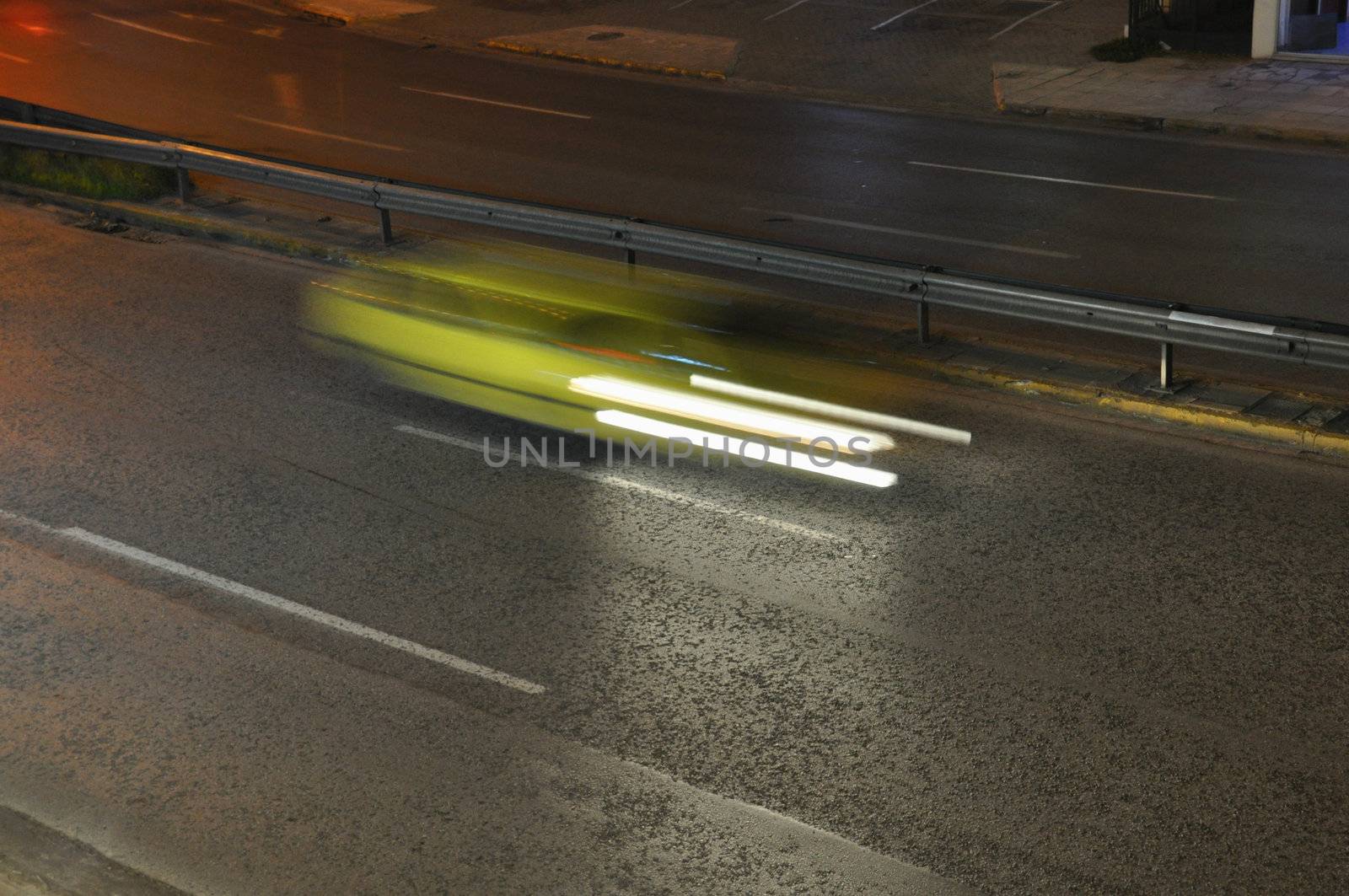 Speeding yellow cab on the motorway city traffic at night. Motion blur.