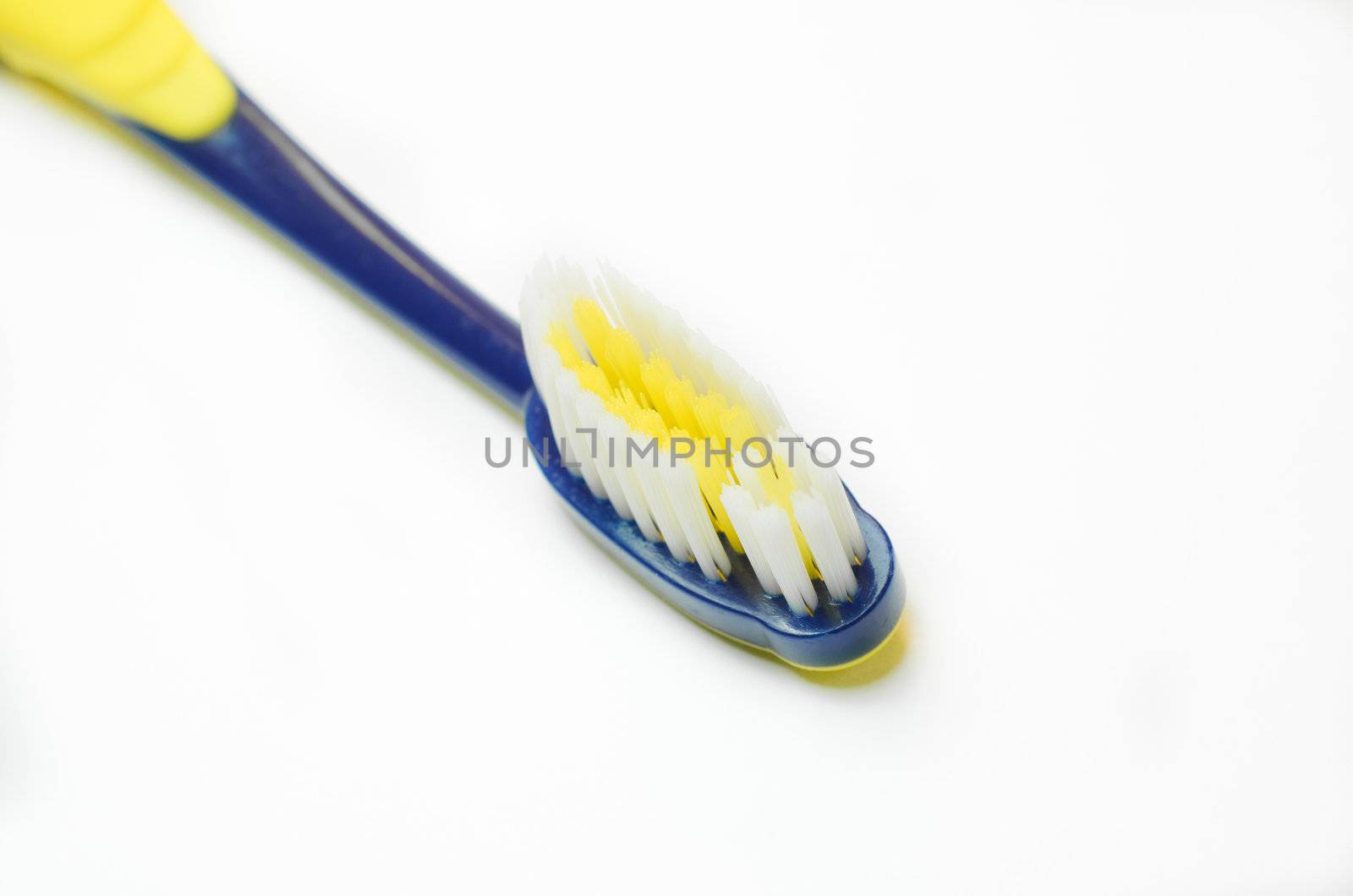 Tooth-brush with blue handle over white background