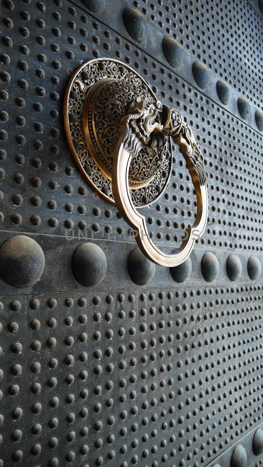 Ancient iron door with a copper doorknob