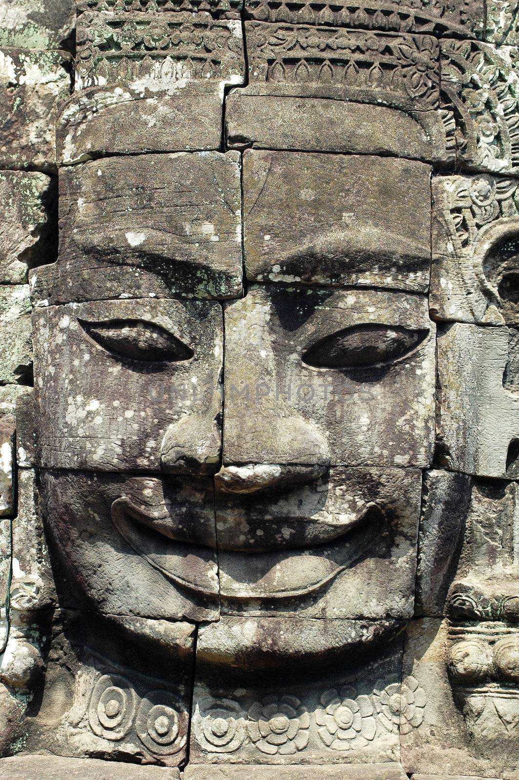 Giant ancient buddha rock statue at Angkor Cambodia