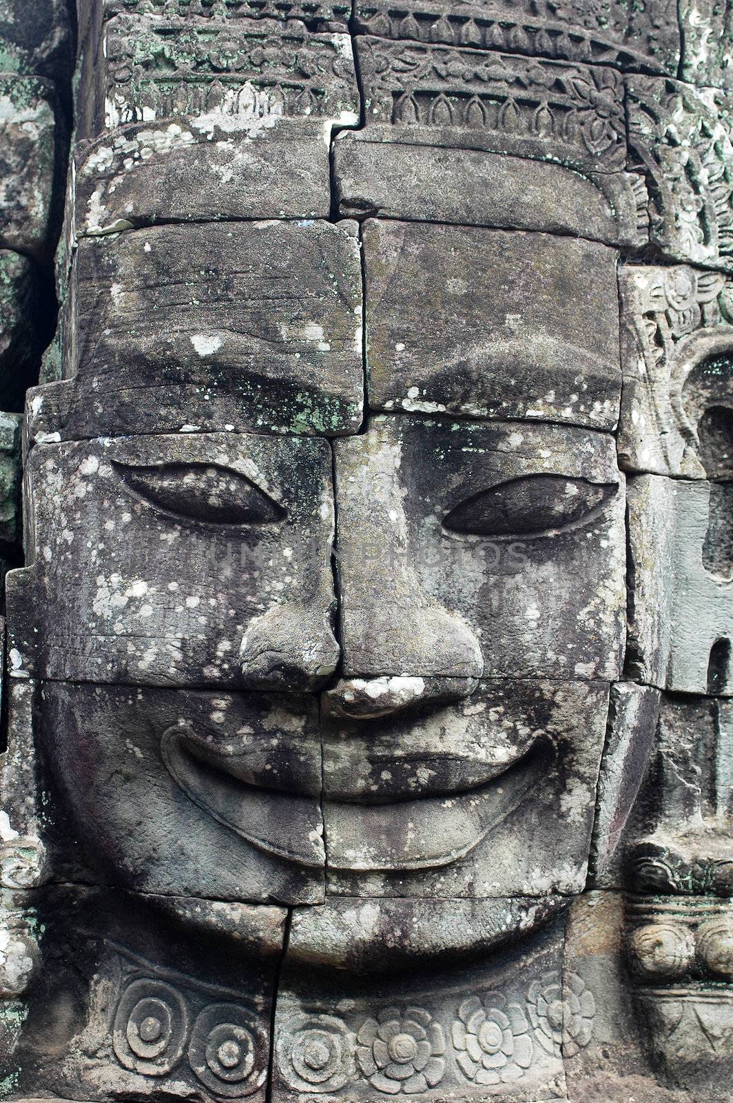 Giant ancient buddha rock statue at Angkor Cambodia