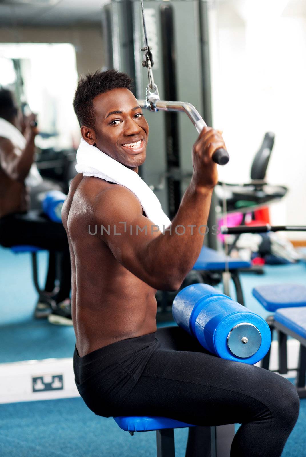 Fit guy working out in gym toning upper and core part of his body