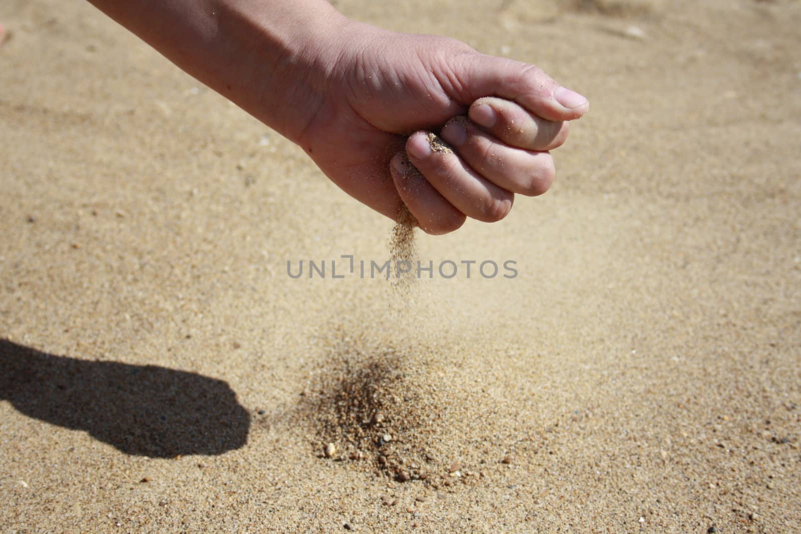 Sand pours from a palm as in a sand-glass