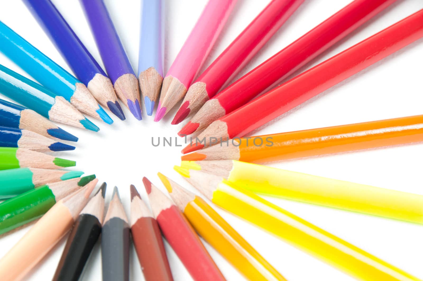 Shot of multicolored pencils in round shape isolated on white