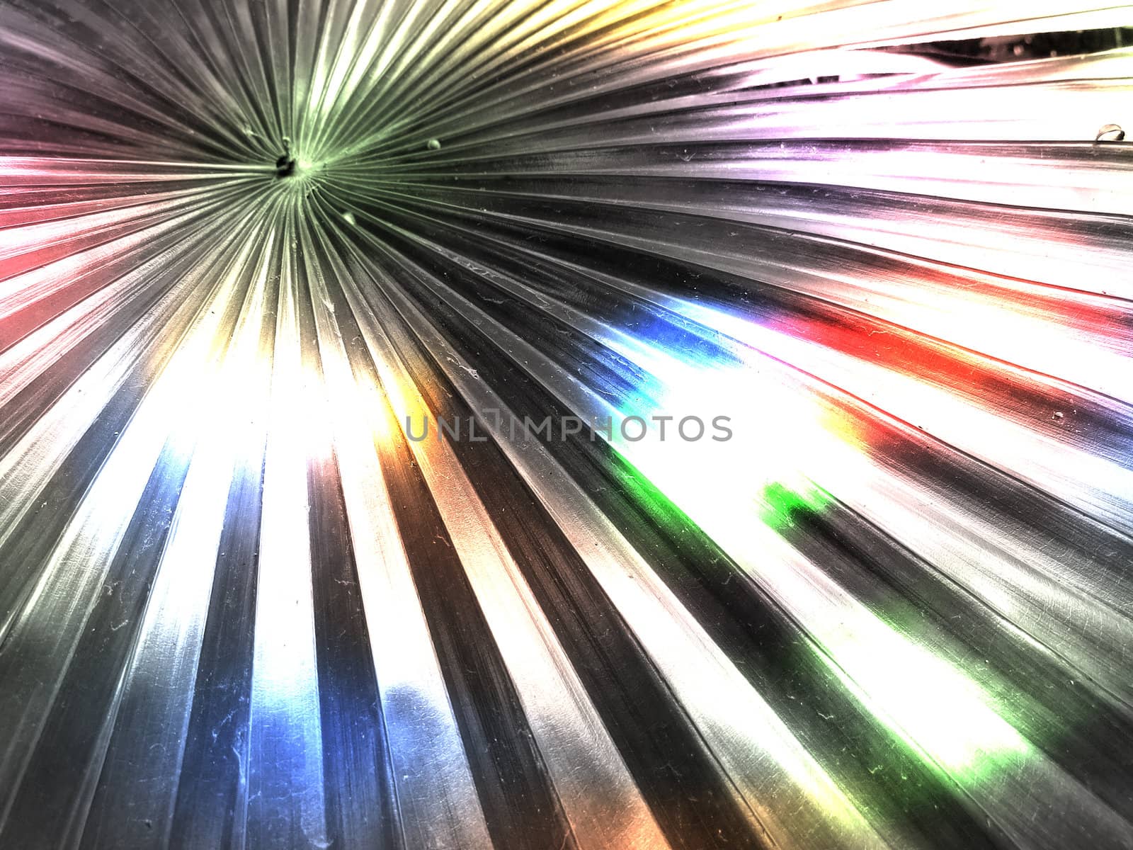 An abstract background of a metallic striped shape with reflections of colorful lights.                               