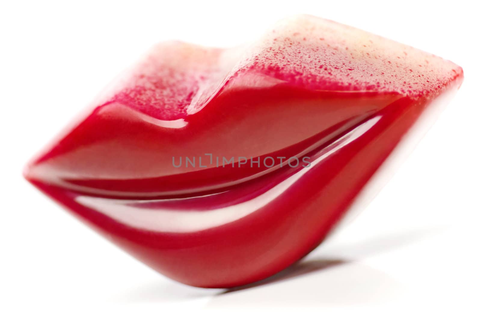 Burgundy Lips shaped Praline on white background.